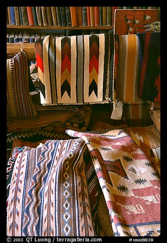 Stacks of varicolored blankets and rugs weaved by Navajo Indians. Hubbell Trading Post National Historical Site, Arizona, USA (color)