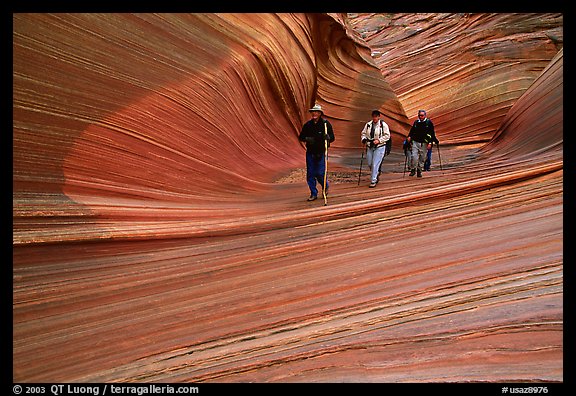 Hikers walk out of the Wave. Vermilion Cliffs National Monument, Arizona, USA
