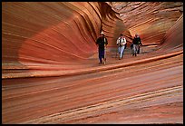 Hikers walk out of the Wave. Vermilion Cliffs National Monument, Arizona, USA