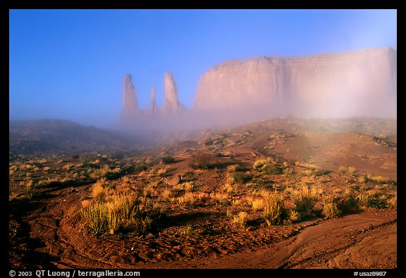 Three sisters, clearing fog, morning. Monument Valley Tribal Park, Navajo Nation, Arizona and Utah, USA