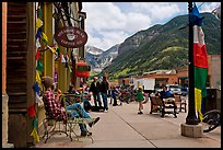Men sitting on main street sidewalk. Telluride, Colorado, USA (color)