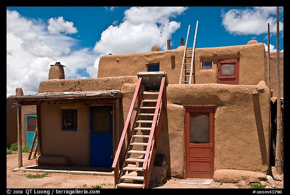 Multi-story pueblo houses with ladders. Taos, New Mexico, USA