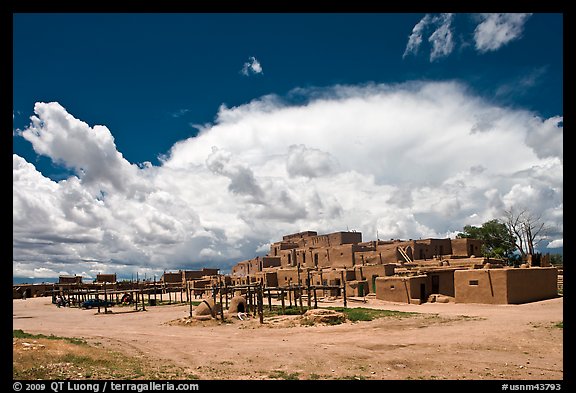 Afternoon cloud hovering over multi-family houses built by Pueblo Indians. Taos, New Mexico, USA (color)