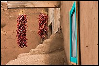 Ristras, adobe walls, and blue window. Taos, New Mexico, USA ( color)