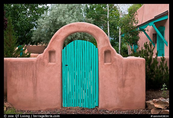 Blue door and adobe yard wall. Taos, New Mexico, USA (color)