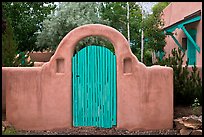 Blue door and adobe yard wall. Taos, New Mexico, USA
