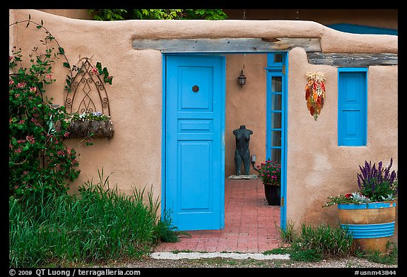 Adobe style walls, blue doors and windows, and courtyard. Taos, New Mexico, USA