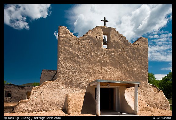 Facade of church covered with tightly compacted earth, clay, and straw, Picuris Pueblo. New Mexico, USA (color)