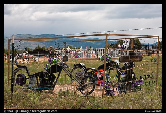 Grave with motorbikes, Truchas. New Mexico, USA