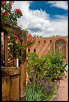 Gardens and adobe wall, Sanctuario de Chimayo. New Mexico, USA (color)