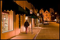 Man walking gallery and St Francis by night. Santa Fe, New Mexico, USA