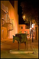 Street with sculpture by night. Santa Fe, New Mexico, USA