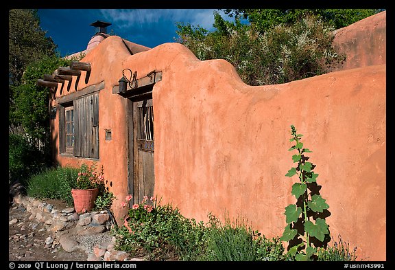 Adobe wall and weathered wooden door and window. Santa Fe, New Mexico, USA (color)