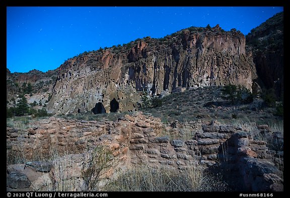 Tyuonyi Pueblo and cliff dwellings by moonlight. Bandelier National Monument, New Mexico, USA (color)