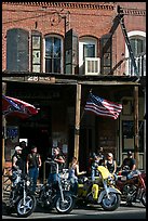 Motorcycles parked in front of brick historic building. Virginia City, Nevada, USA (color)