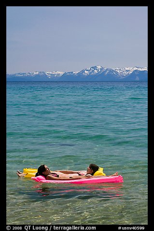 Girls laying on floating mattress, Sand Harbor, East Shore, Lake Tahoe, Nevada. USA (color)