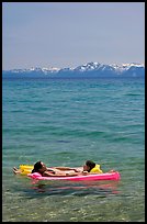 Girls laying on floating mattress, Sand Harbor, East Shore, Lake Tahoe, Nevada. USA (color)