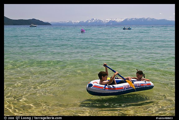 Children playing in inflatable boat, Sand Harbor, Lake Tahoe-Nevada State Park, Nevada. USA (color)