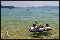 Children playing in inflatable boat, Sand Harbor, Lake Tahoe-Nevada State Park, Nevada. USA (color)
