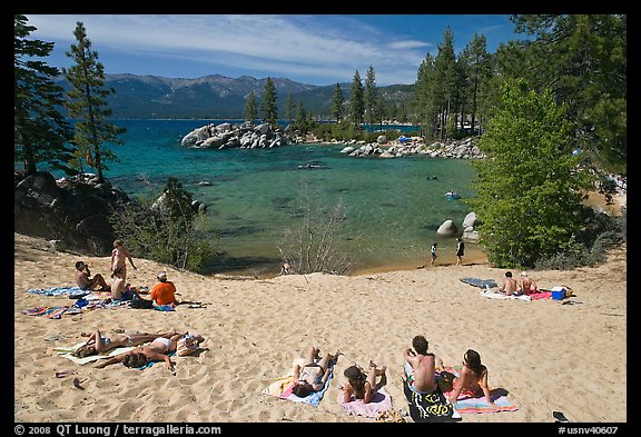 Young people sunbathing on sandy beach, Sand Harbor, Lake Tahoe, Nevada. USA