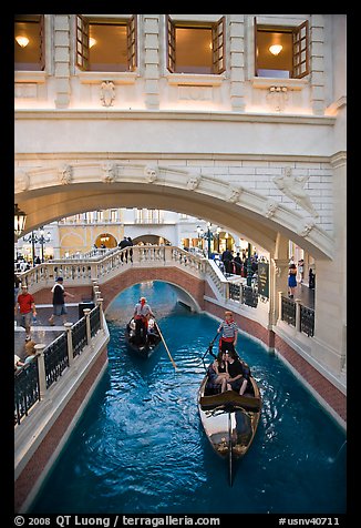 Couple kissing in gondola below bridge, Venetian casino. Las Vegas, Nevada, USA