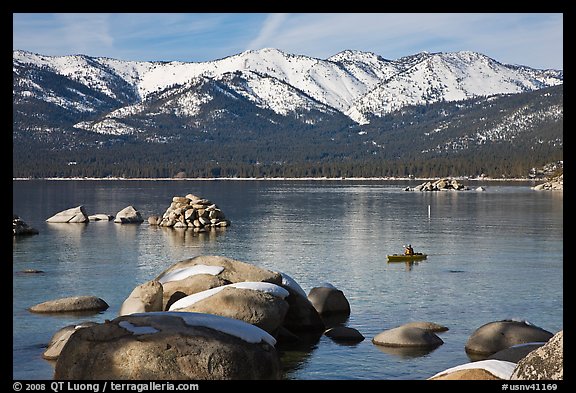Boulders, kayak, and snowy mountains, Sand Harbor, Lake Tahoe-Nevada State Park, Nevada. USA (color)
