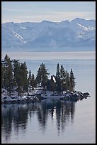 Cabin on lakeshore and snowy mountains, Lake Tahoe, Nevada. USA