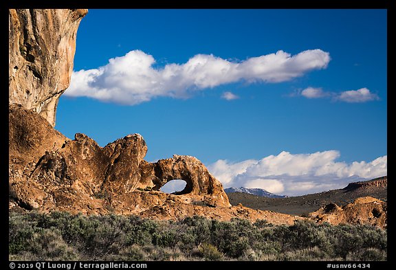 Natural arch and clouds. Basin And Range National Monument, Nevada, USA