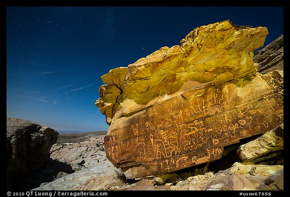 Newspaper Rock with petroglyphs at night with moonlight. Gold Butte National Monument, Nevada, USA (color)
