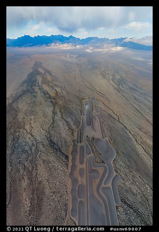 Aerial view of part of Michael Heizer's City leading to mountains. Basin And Range National Monument, Nevada, USA (color)