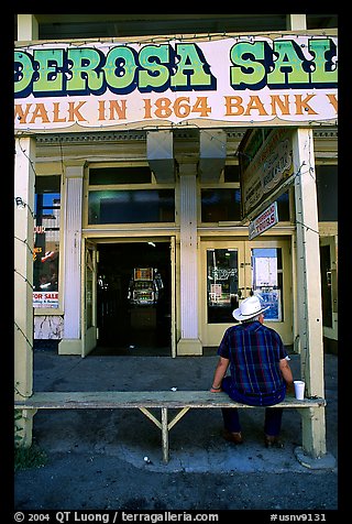 Man with cowboy hat sitting in front of a casino. Virginia City, Nevada, USA