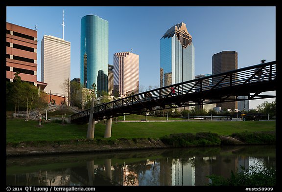 Bridge with bicyclist, reflection, and skyline. Houston, Texas, USA (color)