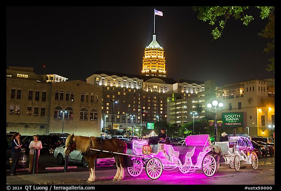 Horse carriages and Tower Life Building at night. San Antonio, Texas, USA