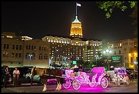 Horse carriages and Tower Life Building at night. San Antonio, Texas, USA ( color)