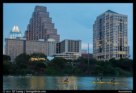 Water pedaling in front of skyline at dusk. Austin, Texas, USA (color)