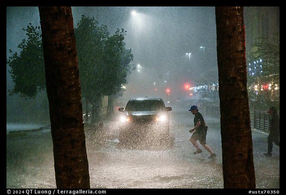 Pedestrian run in torrential rain at night. San Antonio, Texas, USA (color)