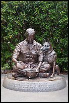 Bronze sculpture depicting Vietnam War dog handler pouring water from canteen into helmet, Military Working Dog Teams National Monument. San Antonio, Texas, USA ( color)
