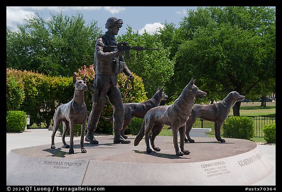 Bronze sculptures of four dogs and handler seated on granite pedestal, Military Working Dog Teams National Monument. San Antonio, Texas, USA