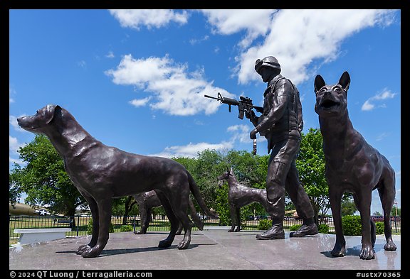 Sculpture of dog handler holding leash and M4 rifle with dogs, Military Working Dog Teams National Monument. San Antonio, Texas, USA