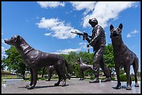 Sculpture of dog handler holding leash and M4 rifle with dogs, Military Working Dog Teams National Monument. San Antonio, Texas, USA ( color)