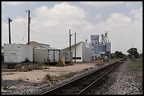 Railroad tracks past grain elevators and utility poles, Marfa. Texas, USA ( color)