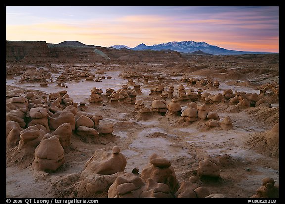 Goblins and snowy mountains at sunrise, Goblin State Park. Utah, USA