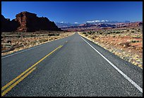 Road, sandstone cliffs, snowy mountains. Utah, USA (color)