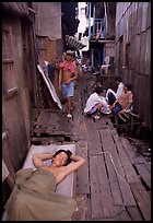 Sleeping late in a narrow alley. Ho Chi Minh City, Vietnam (color)