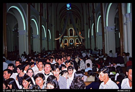 Crowds exit the Cathedral St Joseph at the end of the Christmas mass. Ho Chi Minh City, Vietnam