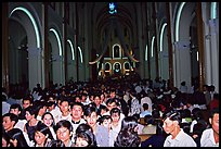 Crowds exit the Cathedral St Joseph at the end of the Christmas mass. Ho Chi Minh City, Vietnam ( color)