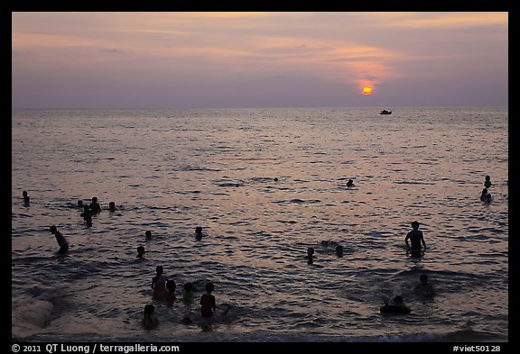 People bathing in Gulf of Thailand waters at sunset. Phu Quoc Island, Vietnam