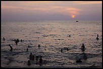 People bathing in Gulf of Thailand waters at sunset. Phu Quoc Island, Vietnam ( color)