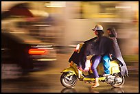 Women riding scooter in the rain. Ho Chi Minh City, Vietnam ( color)