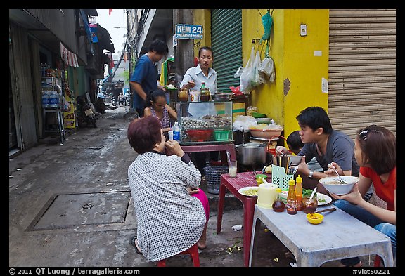 Breakfast at food stall in alley. Ho Chi Minh City, Vietnam